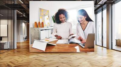 two happy young women in business together Wall mural