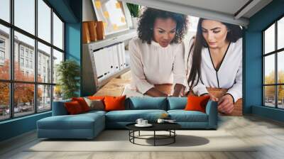 Two hardworking young female entrepreneurs Wall mural