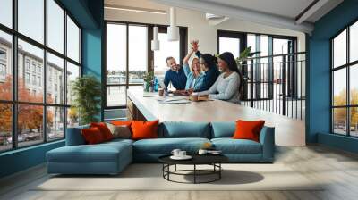 Two laughing coworkers high fiving together during an office mee Wall mural