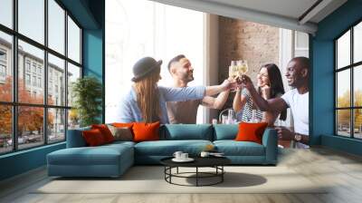 Two mixed couples celebrating with drinks at table Wall mural