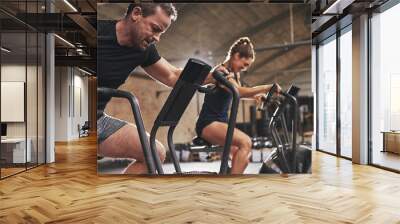 Two young people training toughly in simulators Wall mural