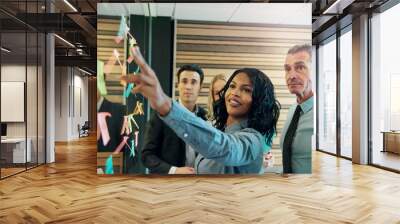 Woman explaining the plan to office team Wall mural