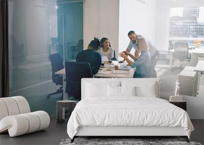 Work colleagues discussing business together during an office me Wall mural