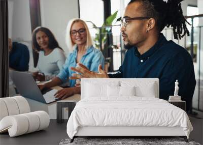 Young African American businessman discussing work with office c Wall mural