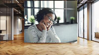 Young African woman smiling and chatting online Wall mural