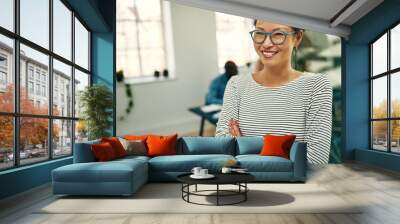 Young Asian businesswoman smiling while working in a modern offi Wall mural