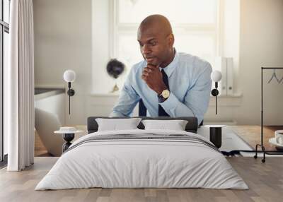 young businessman working on a laptop in an office Wall mural