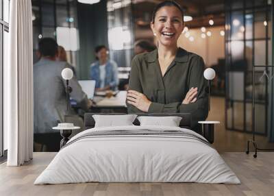 Young businesswoman laughing while working in a modern office Wall mural