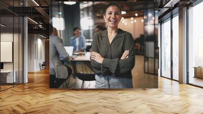 Young businesswoman laughing while working in a modern office Wall mural