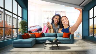 Young women taking a selfie in a fashion boutique Wall mural