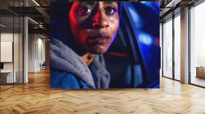 photo of portrait close up view of criminal suspect in crime scene standing in front of police car at night and red blue light, generative AI Wall mural