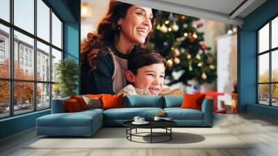 Mother, smile and bonding in home for Christmas, celebration and love together with holiday and hug. Mom, son and happy people in living room for relax, connection and vacation with family embrace Wall mural