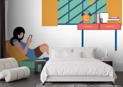 Girl is using phone in bed. Wall mural