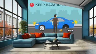 Traffic or road rule. Young male driver changing a flat tire on city road. Keep hazard lights on warning design. Flat vector illustration template. Wall mural