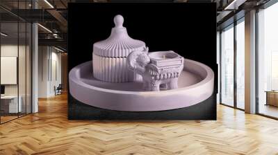 Gypsum products for home decoration. Elephant-shaped candlestick and jewelry box on a tray on a black background, front view, low key, selective focus. Wall mural