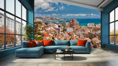 Beautiful above view of the vacation area of Cullera, Spain, showing the city and the coastline with a bright blue sky and white clouds Wall mural