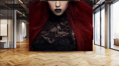 Young woman with red hair in black gothic costume on dark background Wall mural