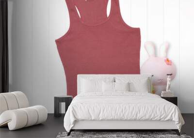 Coral color tank top with soft toy on white background Wall mural