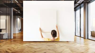 Blank canvas with empty mockup copy space in female hands. Minimal art concept. Wall mural