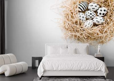 Fancy Easter eggs in nest on white background. Flat lay, top view. Traditional spring concept. Wall mural