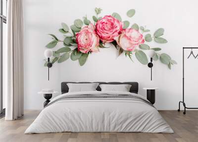 Floral composition with pink rose flower buds and eucalyptus on white background. Flat lay, top view. Blog hero header. Wall mural