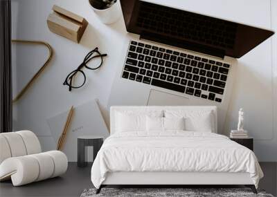 Home office desk workspace with laptop, notebook, glasses on white table. Flat lay, top view minimal women's, girl boss background. Wall mural