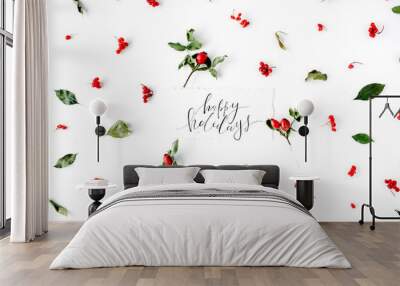 words happy holidays and minimal creative berry arrangement pattern on white. flat lay, top view. christmas background wallpaper. Wall mural