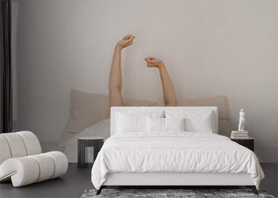 Young woman hands in bed with white linens. Bright happy morning concept Wall mural