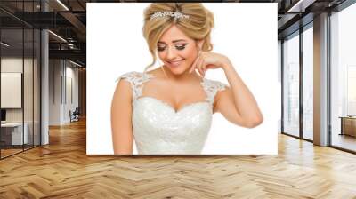 A beautiful bride with blonde hair smiles gently while wearing an elegant lace wedding dress and a jeweled hair accessory Wall mural