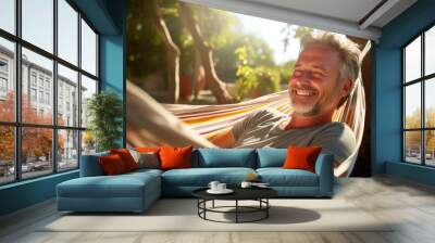 A man in a hammock, enjoying the sunshine Wall mural