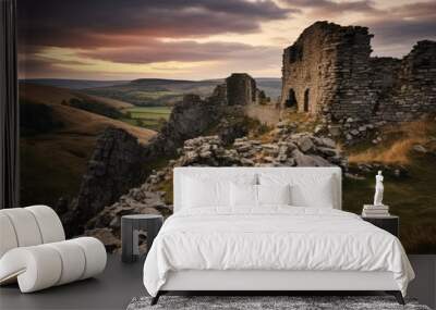 A ruined castle on a hilltop overlooking a valley. The castle is made of stone and is in a state of disrepair with crumbling walls and collapsed sections Wall mural