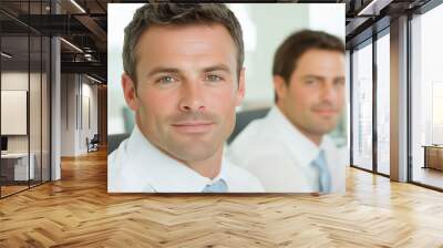 Close-up of two confident businessmen in a bright office, both wearing formal attire and looking professional Wall mural