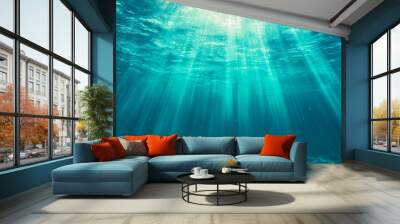 Underwater view of sunlight rays penetrating the ocean surface Wall mural