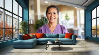 Young hispanic nurse , wearing light purple medical scrubs Wall mural