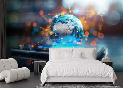 A glass globe representing the Earth sits on top of a smart phone, with an out of focus background. Wall mural