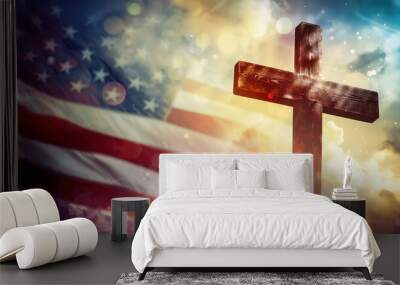 A wooden cross stands tall against a blurred background of an American flag and glowing light. Wall mural