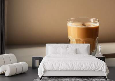 A glass of coffee with a few coffee beans on the table Wall mural