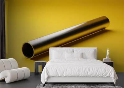 A long, thin, silver pipe is on a yellow background Wall mural