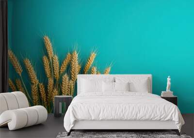 Golden Wheat Ears Against Blue Sky Background in Minimalist Artistic Composition Wall mural