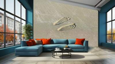  two footprints on the sand. Wall mural