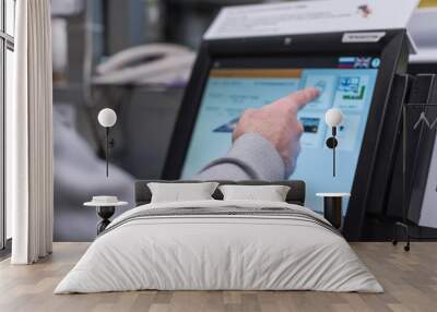 Man paying at the self-service counter using the touchscreen display and credit card. Isometric self-service cashier or terminal. Wall mural