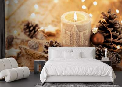 Christmas background - Advent candle with natural Xmas decoration, branches and pine cones on rustic wood Wall mural