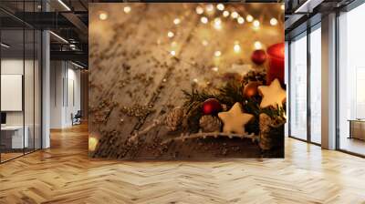 Christmas background - First Advent Sunday - Red Advent candle with natural Xmas decoration, branches and pine cones on rustic wood with magic lights Wall mural