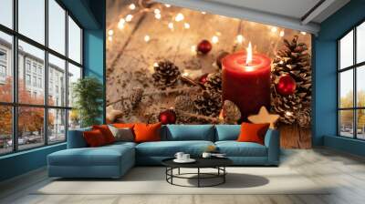 Christmas background - Red Advent candle with natural Xmas decoration, branches and pine cones on rustic wood Wall mural