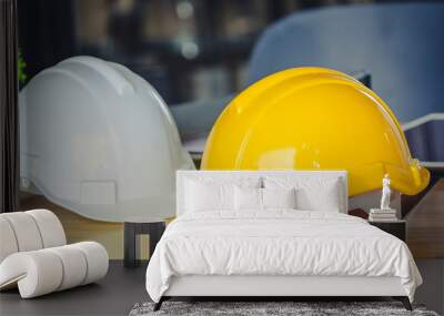 Hat engineers white and yellow on a wooden table. Wall mural