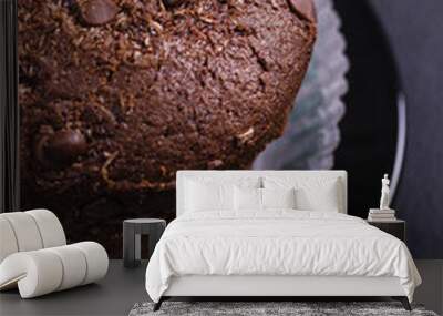 Chocolate muffin on a dark table, side view Wall mural