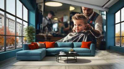 Cute little boy at the barber shop getting his haircut  Wall mural