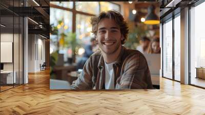 a young man works on his laptop, in a co working space Wall mural