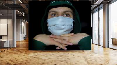 Adolescent boy in medicine Mask and Hoodie. Coronavirus epidemic Wall mural