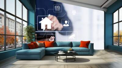 Hand using AI smart tablet with smart home app on the room, circular interface of the smart home automation assistant on the virtual screen and user touches the button, smart home digital interface  Wall mural